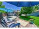 A wood deck features seating, a table, and a barbecue in a fenced backyard at 3313 S Dexter St, Denver, CO 80222