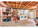 The basement offers a washer, dryer, sink, and storage shelving at 3313 S Dexter St, Denver, CO 80222