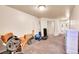 Basement gym area with fitness equipment, carpeted flooring, and ample space at 3313 S Dexter St, Denver, CO 80222