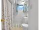 A compact bathroom features a tub and shower, window and vanity at 3313 S Dexter St, Denver, CO 80222