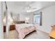 Bedroom with a ceiling fan, cozy bedding, carpeted floors, and natural lighting at 3313 S Dexter St, Denver, CO 80222