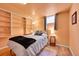 Bedroom with a comfortable bed, built-in shelves, and natural lighting at 3313 S Dexter St, Denver, CO 80222