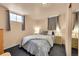 Cozy bedroom featuring soft bedding, carpeted floors, and natural lighting at 3313 S Dexter St, Denver, CO 80222