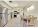 Bright kitchen with stainless steel appliances, tiled floors, and a dining area at 3313 S Dexter St, Denver, CO 80222