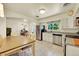 Modern kitchen featuring stainless steel appliances, tiled floors, and a large dining table at 3313 S Dexter St, Denver, CO 80222