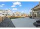 Large backyard featuring a spacious concrete patio and a gravel area, ideal for outdoor entertainment and relaxation at 10909 Memphis Ct, Commerce City, CO 80022