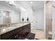 Bright Primary bathroom with double vanity, granite countertop and a glass enclosed shower at 10909 Memphis Ct, Commerce City, CO 80022