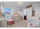 Bright Bedroom with a crib, changing table, and decor creating a cozy atmosphere, complemented by natural light at 10909 Memphis Ct, Commerce City, CO 80022