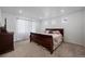 Bright bedroom with carpeted floors, recessed lights, white walls and a dark wood queen-sized bed at 10909 Memphis Ct, Commerce City, CO 80022