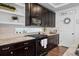 Modern kitchen features granite countertops, dark wood cabinets, a gas range, and stainless steel appliances at 10909 Memphis Ct, Commerce City, CO 80022