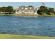 Waterfront clubhouse with multiple entrances on a lake setting, complete with an American flag waving in the breeze at 10909 Memphis Ct, Commerce City, CO 80022