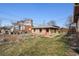 A charming backyard with a detached brick structure and partial lawn at 2301 Vine St, Denver, CO 80205