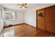 Bedroom featuring hardwood floors, window, and closet with wood doors at 2301 Vine St, Denver, CO 80205