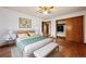 Comfortable bedroom featuring hardwood floors and a closet with wood sliding doors at 2301 Vine St, Denver, CO 80205