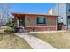Charming brick home featuring a cozy front porch and well-maintained landscaping at 2301 Vine St, Denver, CO 80205