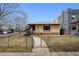 Quaint home with a fenced yard and charming walkway leading to the front entrance at 2301 Vine St, Denver, CO 80205