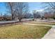 Expansive front yard with a sidewalk, complemented by mature trees, offering a welcoming view at 2301 Vine St, Denver, CO 80205