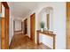 Inviting hallway with wood floors and a decorative console table with decor at 2301 Vine St, Denver, CO 80205