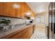 Classic kitchen with wood cabinets, updated appliances and tile backsplash at 2301 Vine St, Denver, CO 80205