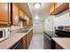 Basement kitchen with wood cabinets, stainless steel appliances, and ample counter space at 2301 Vine St, Denver, CO 80205