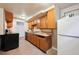 Basement kitchen featuring wooden cabinets and modern appliances at 2301 Vine St, Denver, CO 80205