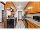 Galley kitchen features appliances, wood cabinetry, and checkered floors at 2301 Vine St, Denver, CO 80205