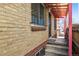 Covered side entrance featuring a secure door and brick accents at 2301 Vine St, Denver, CO 80205