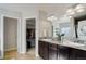 Bathroom featuring double sinks with granite countertops and an open door to walk-in closet at 3733 S Perth Cir # 101, Aurora, CO 80013