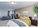 Bedroom with bed, desk, sofa and plant that is perfect for relaxing and working at 3733 S Perth Cir # 101, Aurora, CO 80013