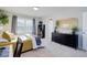 Bright bedroom with large window, gray curtains, black dresser, gold mirror, and overhead lighting at 3733 S Perth Cir # 101, Aurora, CO 80013