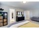 Light and airy bedroom with walk-in closet, black dresser with gold mirror, and comfortable seating area at 3733 S Perth Cir # 101, Aurora, CO 80013