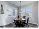 Bright and airy dining space featuring a round table with black chairs, and large windows with shutter blinds at 3733 S Perth Cir # 101, Aurora, CO 80013