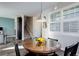 Cozy dining area with dark wood table and chairs, complemented by a modern pendant light and bright natural light at 3733 S Perth Cir # 101, Aurora, CO 80013