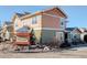 Two-story home exterior featuring a mix of siding, and landscaped yard with signage at 3733 S Perth Cir # 101, Aurora, CO 80013