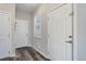 Hallway with dark wood flooring and neutral walls features doors with updated hardware at 3733 S Perth Cir # 101, Aurora, CO 80013