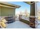 Covered porch with stacked stone columns, a wooden bench, and views of the neighborhood at 3733 S Perth Cir # 101, Aurora, CO 80013