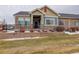 Tan and blue exterior of a ranch-style home with landscaping at 12444 Madison Way, Thornton, CO 80241