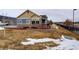 Side view of the house, showing landscaping and a walkway at 12444 Madison Way, Thornton, CO 80241