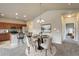 Open-concept kitchen and dining area with modern appliances and plenty of counter space for cooking and entertaining at 12444 Madison Way, Thornton, CO 80241