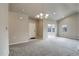 Bright and airy living room with a view from a sunroom at 12444 Madison Way, Thornton, CO 80241