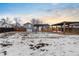 Large backyard with snow and a view of the house at 2610 W 90Th Pl, Denver, CO 80260