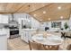 Modern kitchen with white cabinetry, stainless steel appliances, and breakfast nook at 2610 W 90Th Pl, Denver, CO 80260