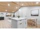 Modern kitchen island with white cabinets and stainless steel appliances at 2610 W 90Th Pl, Denver, CO 80260