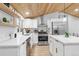 Modern kitchen with white cabinets, quartz countertops, and stainless steel appliances at 2610 W 90Th Pl, Denver, CO 80260