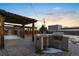 Outdoor patio area with pergola and built-in grill at 2610 W 90Th Pl, Denver, CO 80260