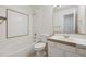 Clean bathroom featuring a tub with shower and vanity with a tiled backsplash at 5928 E Conservation Dr, Frederick, CO 80504