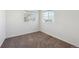 Neutral bedroom with two windows and carpet flooring at 5928 E Conservation Dr, Frederick, CO 80504