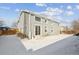 Two-story home with gray siding and a snowy backyard at 5928 E Conservation Dr, Frederick, CO 80504