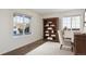 Cozy home office featuring natural light from two windows and a wooden bookshelf at 5928 E Conservation Dr, Frederick, CO 80504