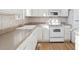 White kitchen with updated appliances and tile backsplash at 5928 E Conservation Dr, Frederick, CO 80504